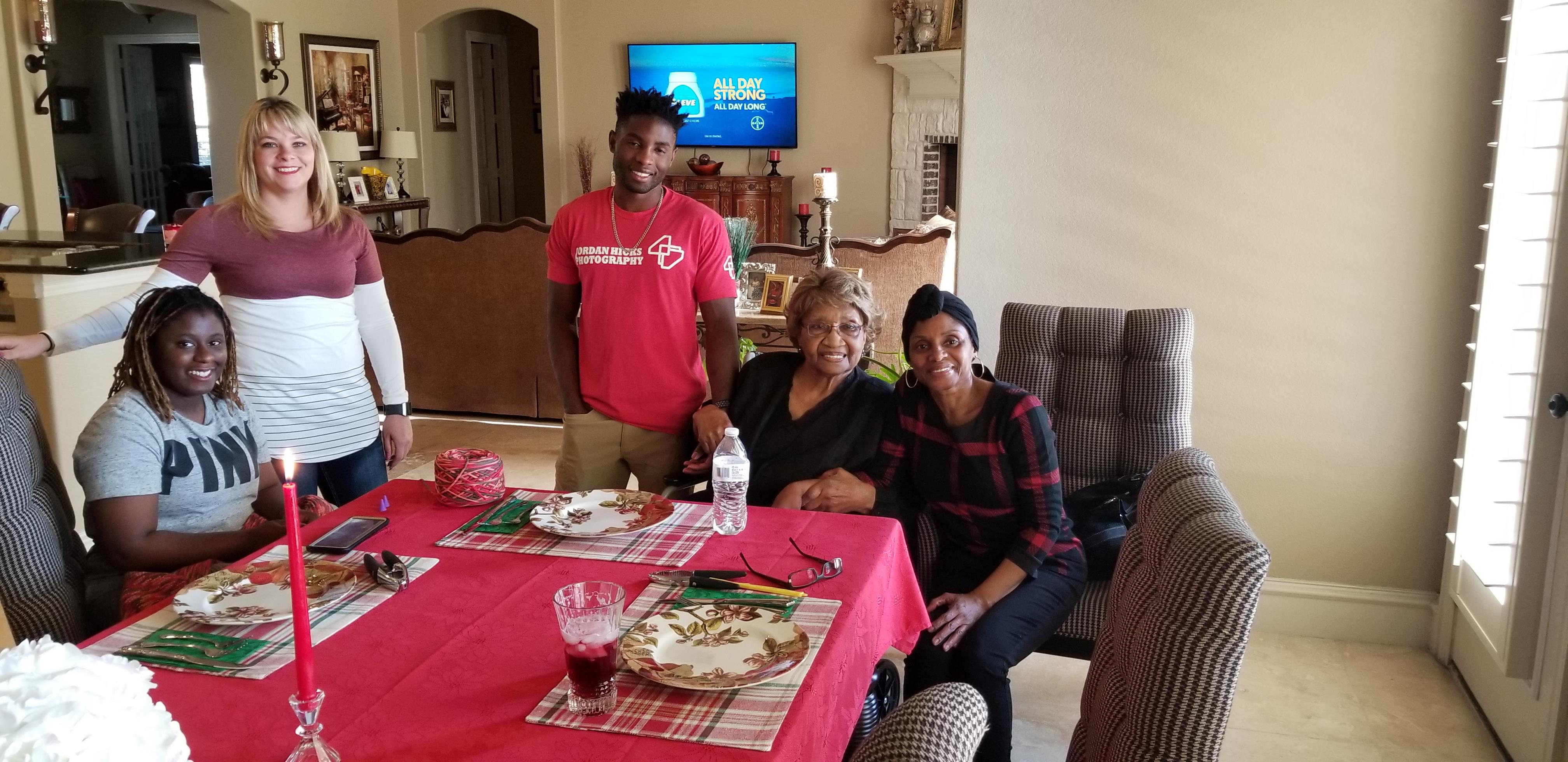 Friends and family enjoy a lively meal at a decorated table, sharing laughter and memories.