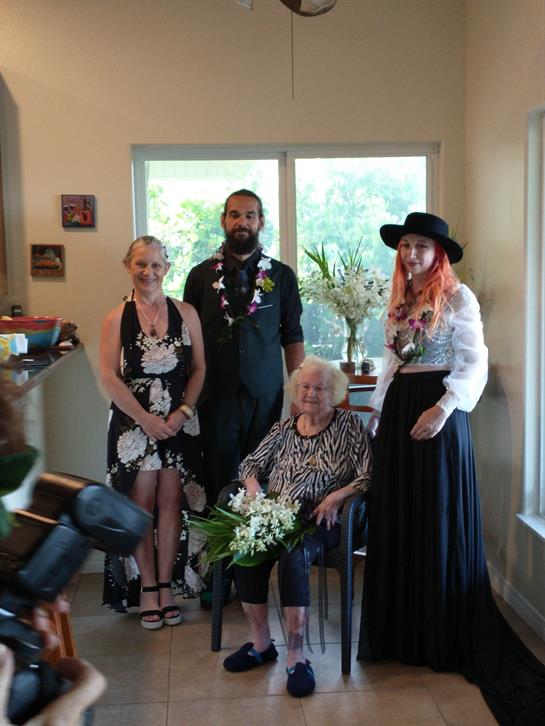 Family members pose together in a warm home setting, highlighting a celebratory moment.