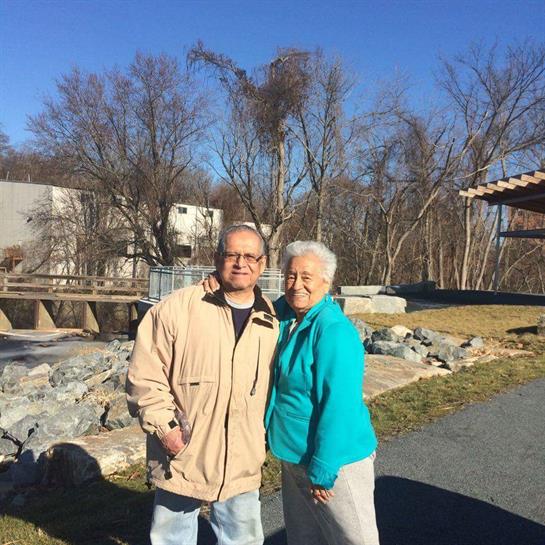 A man and woman standing together outside