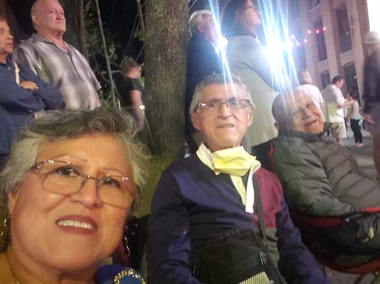 A group of people sitting outside