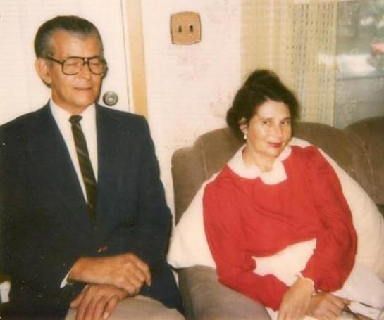 A couple enjoys each other's company in a warm, inviting living room setting.