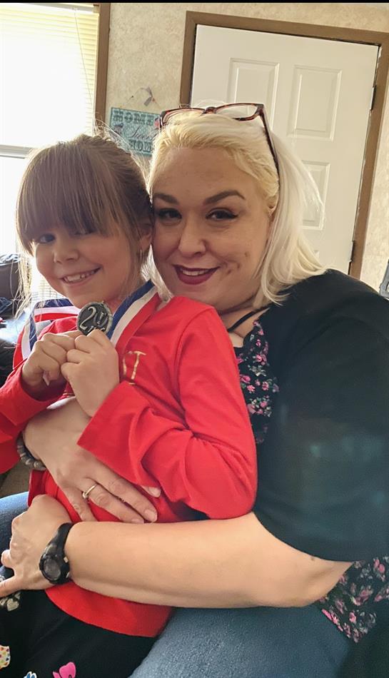 A woman and a girl posing for a picture