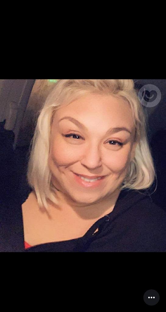 A woman smiling for a selfie