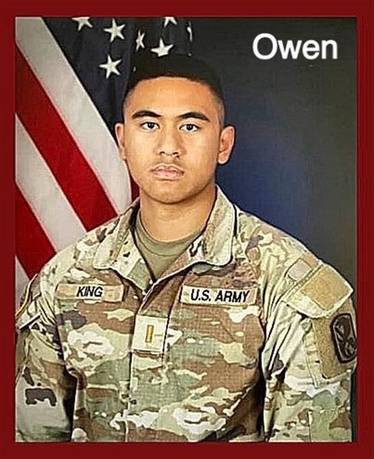 A soldier stands proudly in uniform with an American flag behind, exuding a sense of duty and honor.