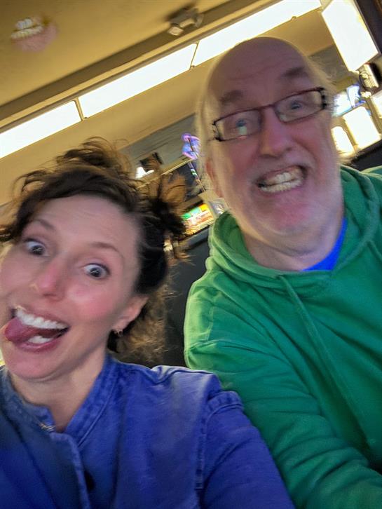 Two friends make funny faces while enjoying each other's company in a relaxed atmosphere.