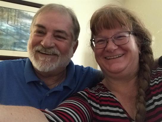 A man and woman smiling for a selfie