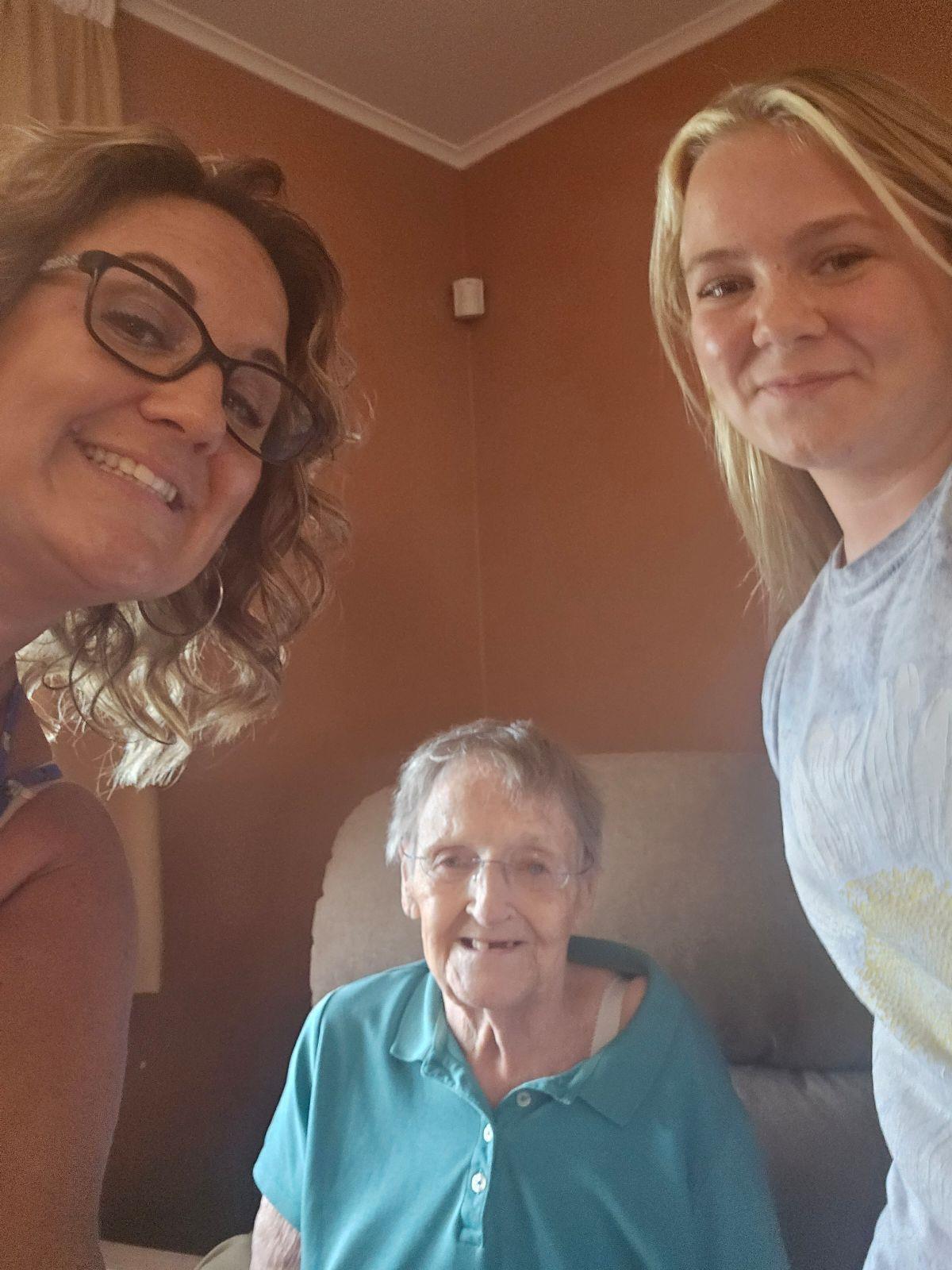 Family members gather, sharing smiles and warmth in a cozy living room setting.