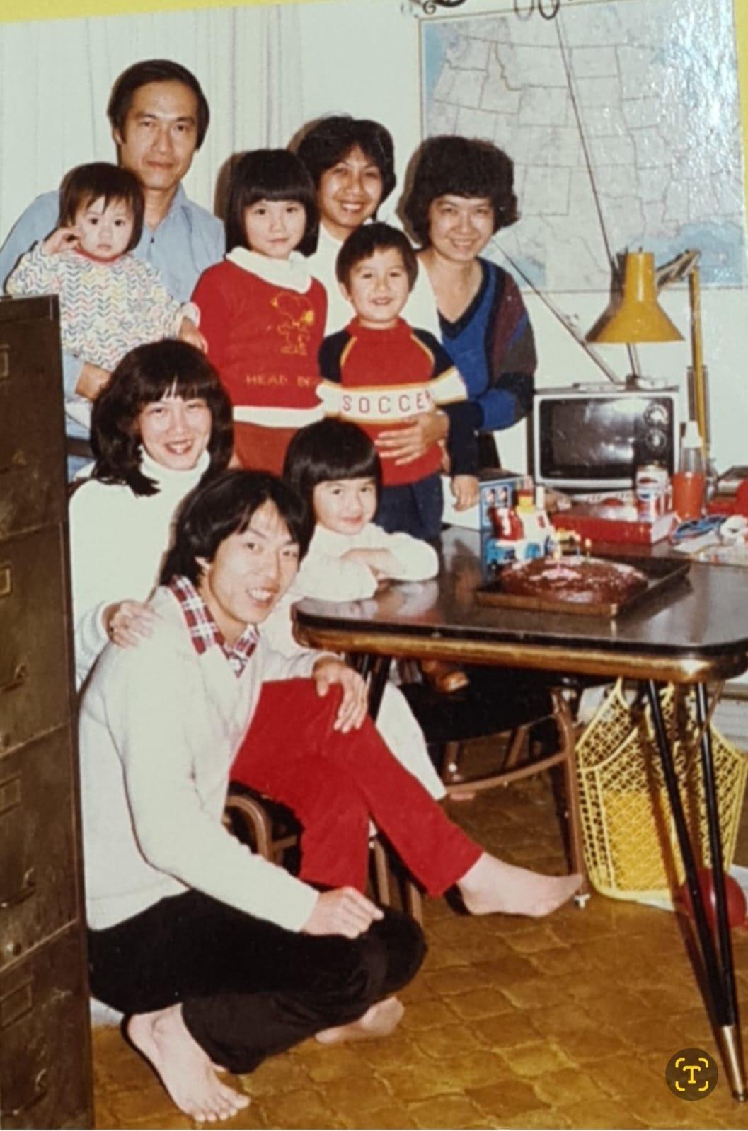 A happy family gathers in a warm, laughter-filled living room for a celebration.