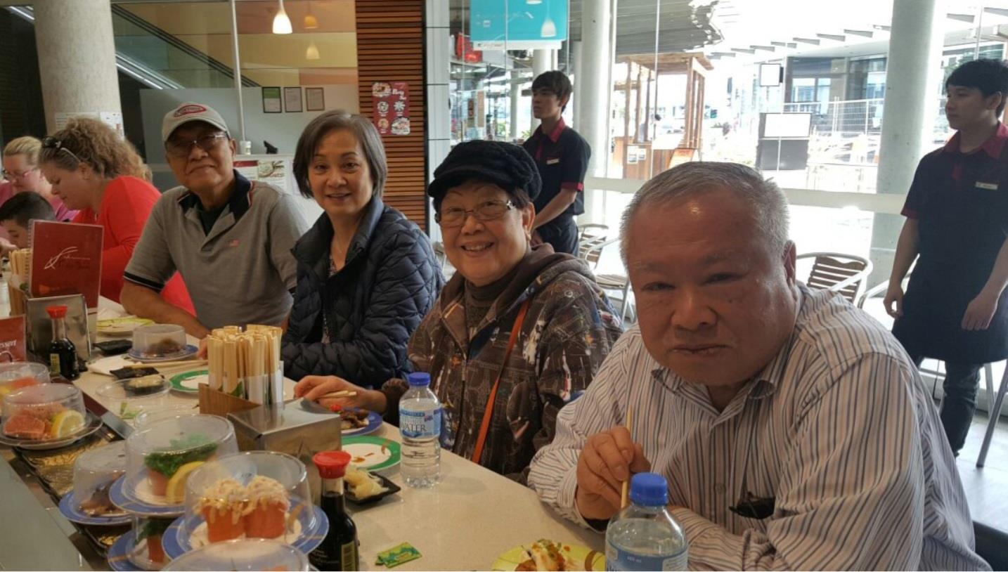 Friends gather to share a meal, laughing and enjoying each other's company in a relaxed atmosphere.