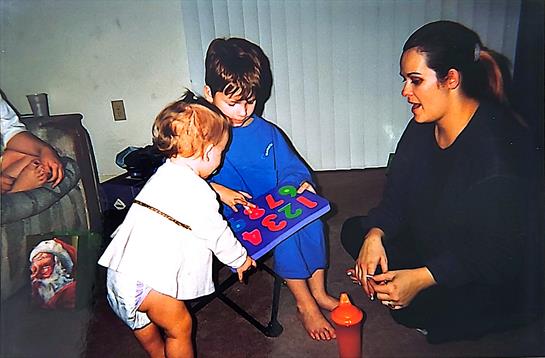 A woman and a child playing with a toy