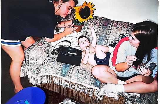 A woman and a baby on a couch