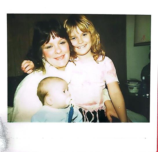 A woman and two children posing for a picture