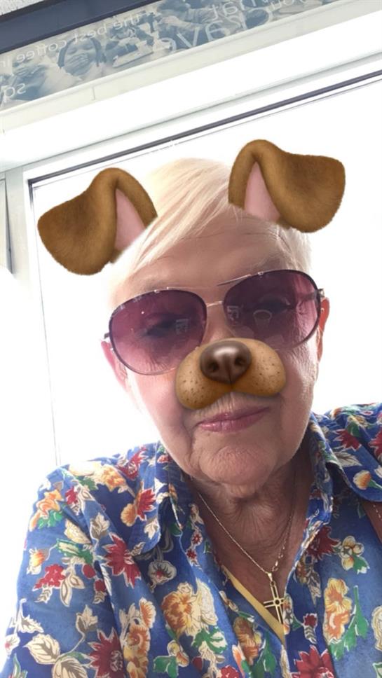 A woman wearing sunglasses and dog ears