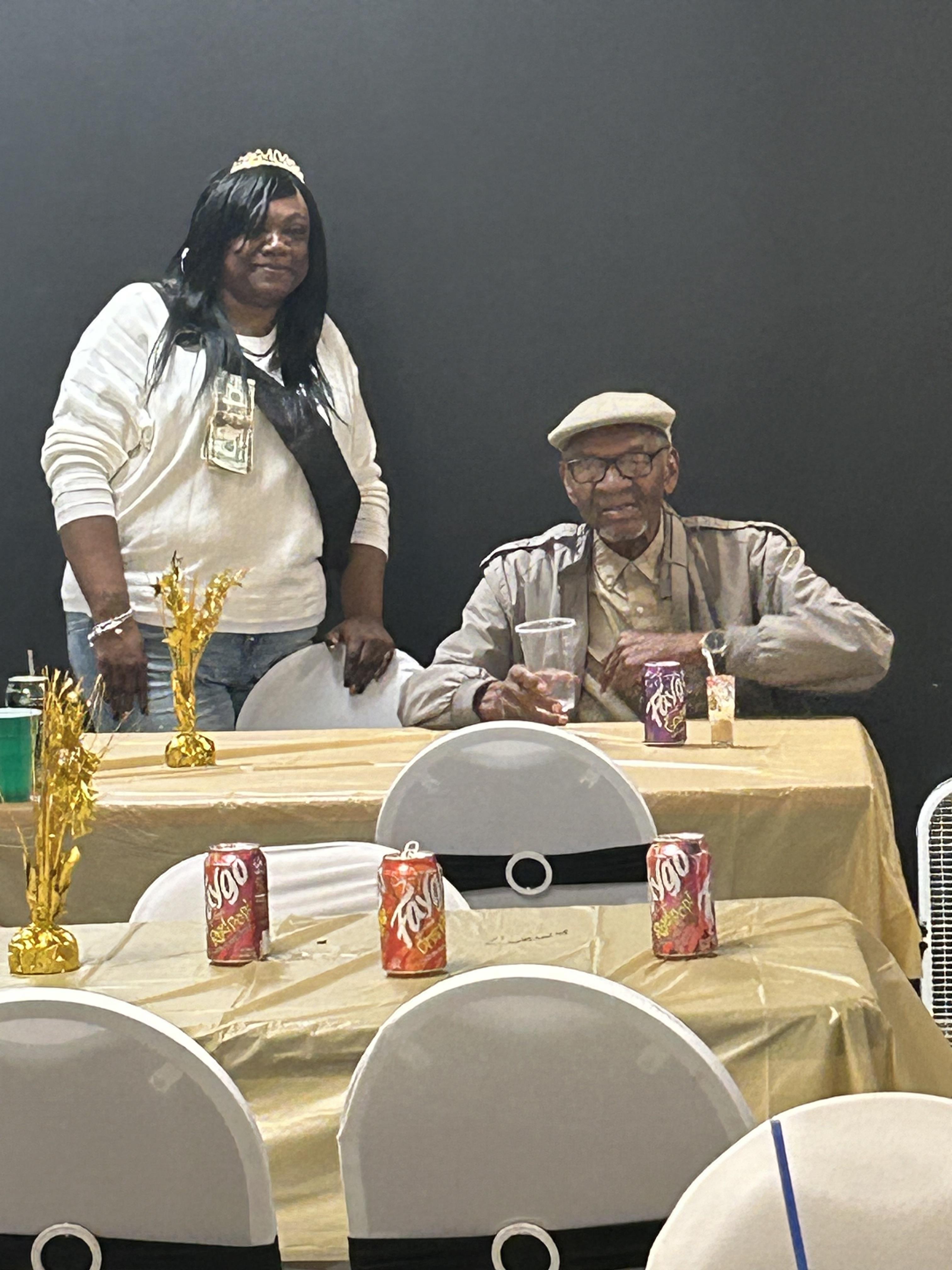 Guests enjoy a celebration with refreshments while surrounded by awards and decorations.