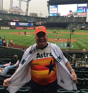 A joyful fan displays his team jersey at Safeco Field while waiting for the game to begin.