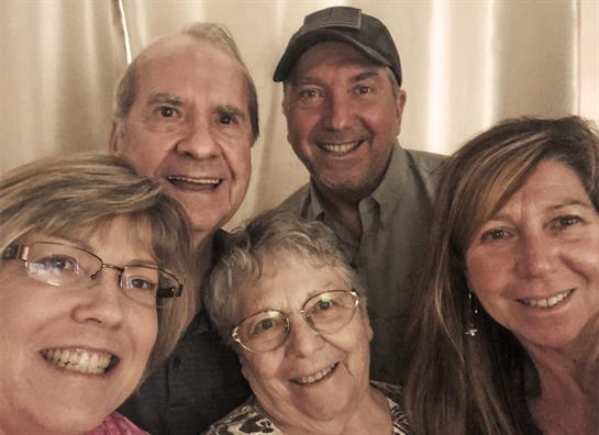 Friends gather, sharing warm smiles and a sense of camaraderie in a relaxed atmosphere.