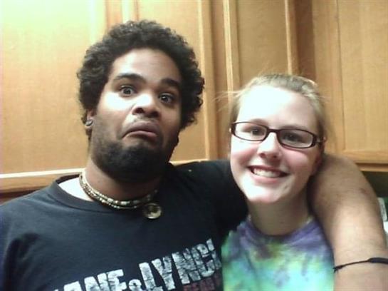 Two friends smile and enjoy their time together in a cozy kitchen setting.