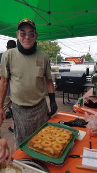A man standing next to a tray of food