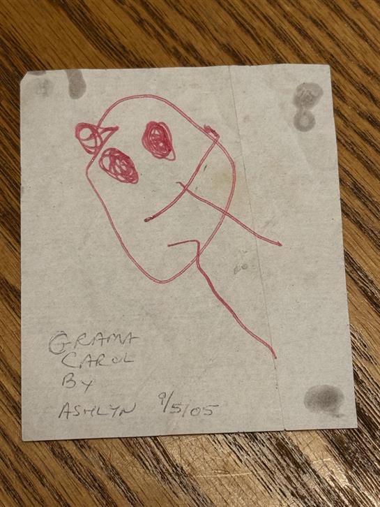 A piece of paper with a drawing of a person's face
