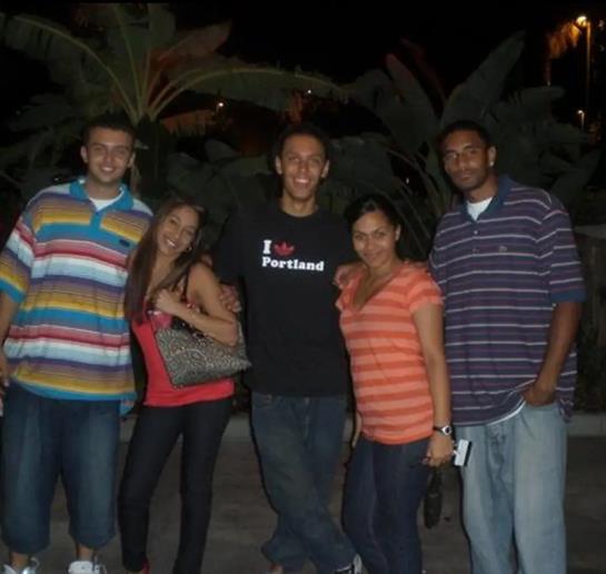 Friends gather for a fun night out, smiling and posing together under the nighttime sky.