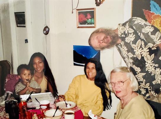 A joyful gathering of friends and family enjoying a meal together in a warm, inviting home.