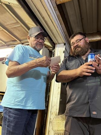 Two men standing in a garage