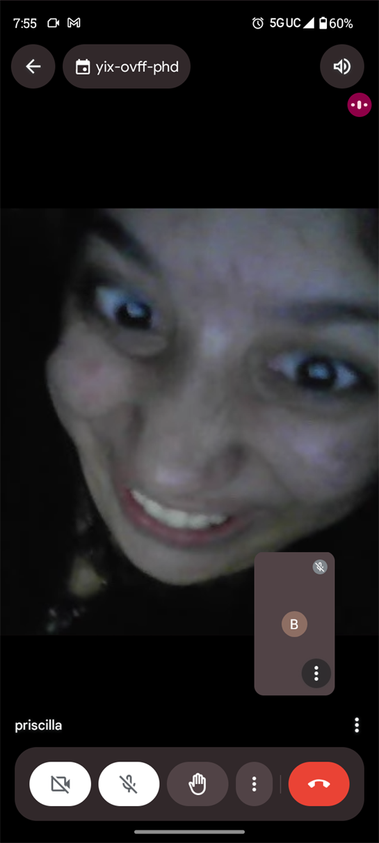 Person is showing a big smile while engaging in a video call late at night.