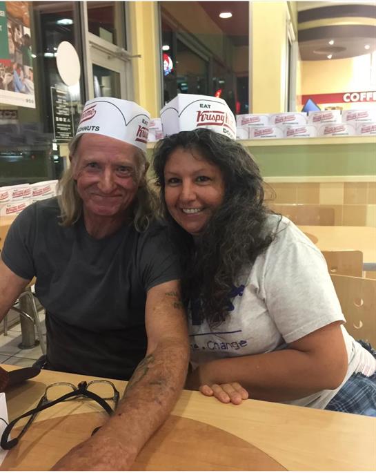 A man and woman wearing paper hats
