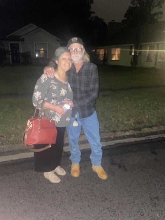 A man and woman standing on a street