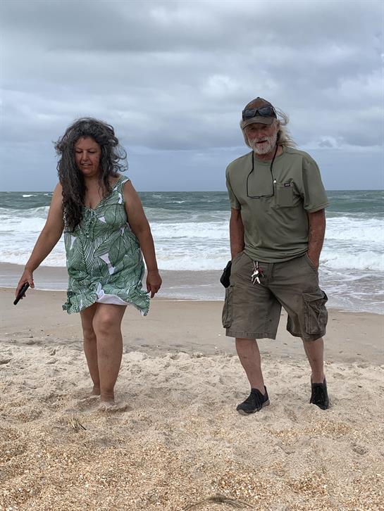 A man and woman standing on a beach