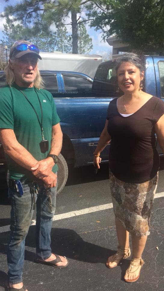 A man and woman standing in a parking lot