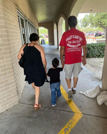 A man and woman walking with a child
