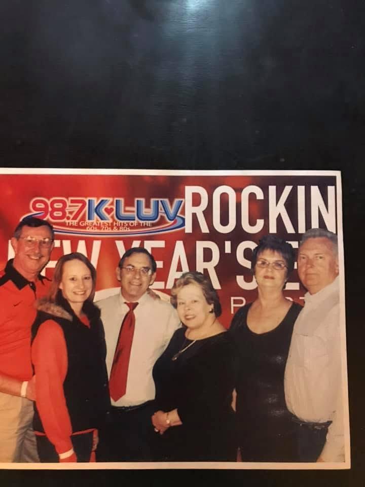 Friends gather together to celebrate New Year's Eve with laughter and joy at a lively event.