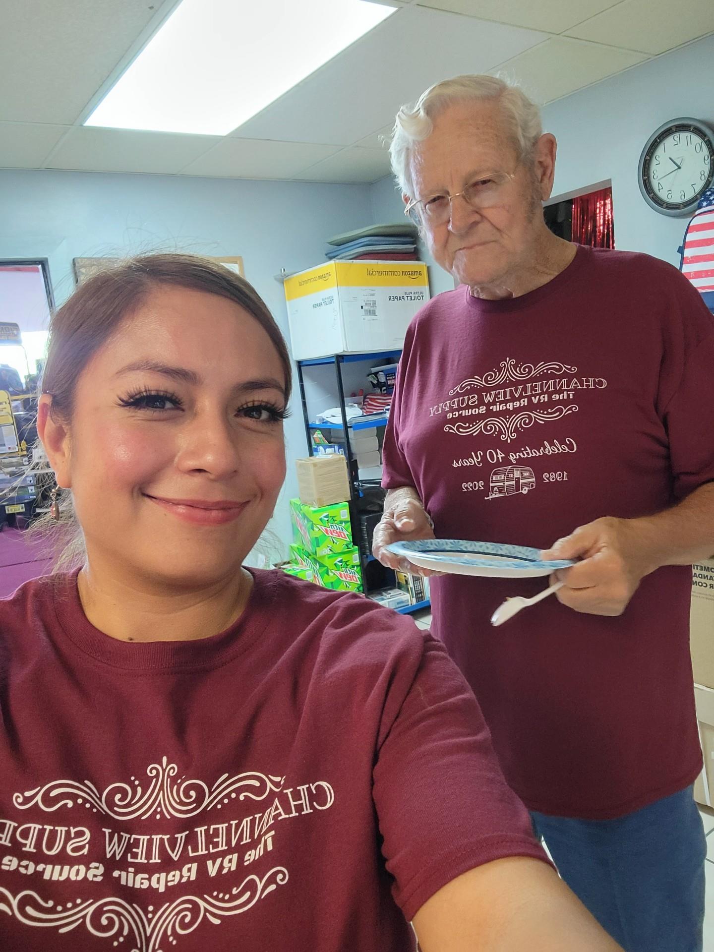 Two volunteers collaborate in a community kitchen, preparing meals for their local area.