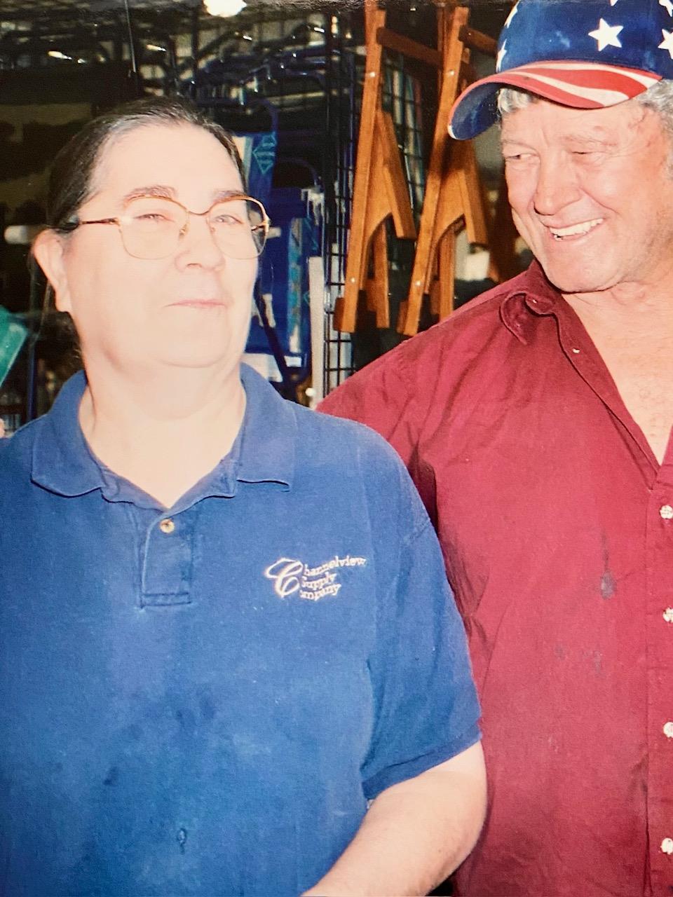 Two friends share a lighthearted exchange while standing in a lively venue.