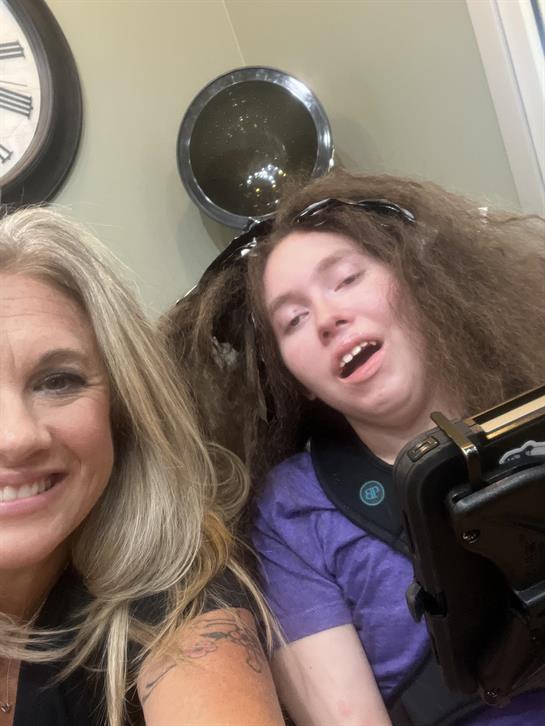 A woman taking a selfie with a boy