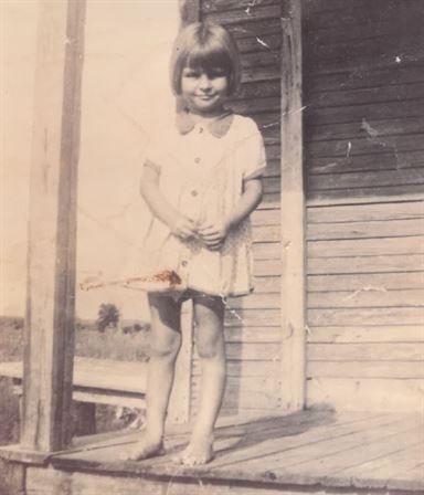 A girl standing on a porch