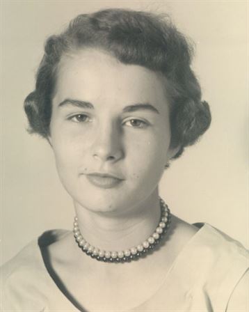 A woman with short hair wearing a necklace