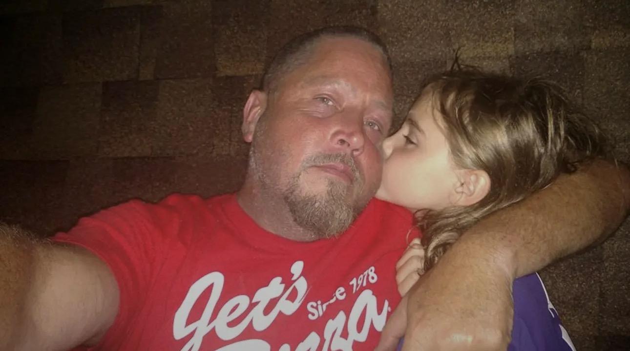A girl kissing a man's cheek
