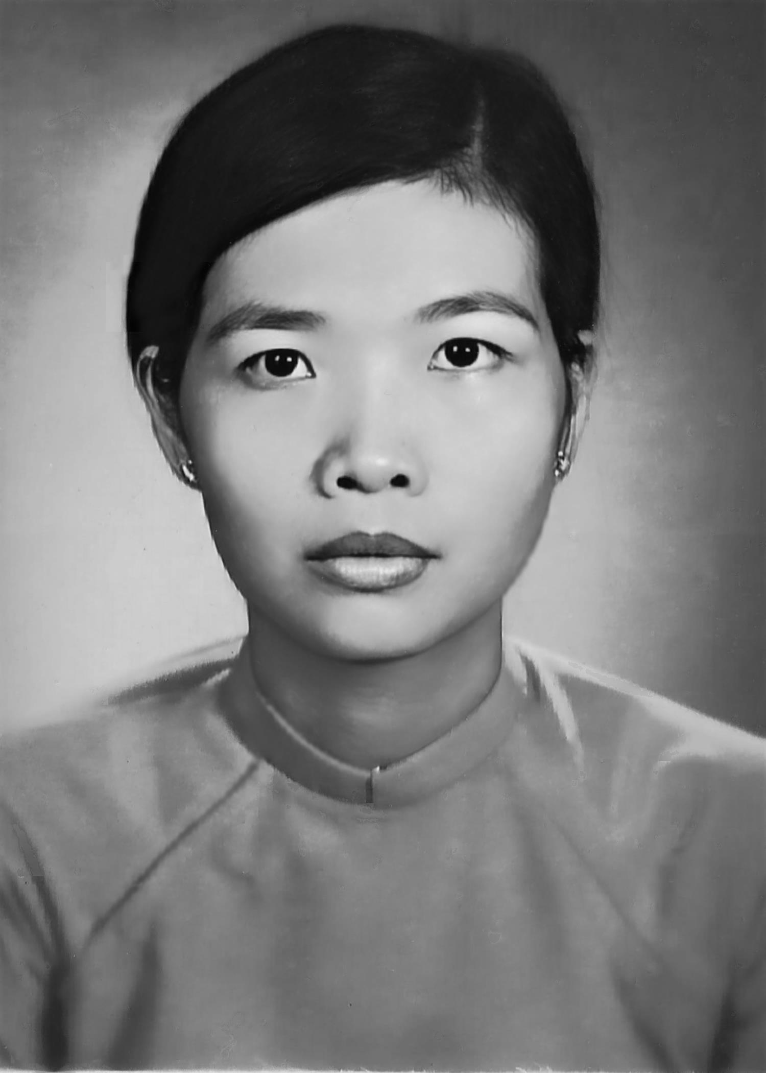 A young woman dressed in traditional attire stares directly at the camera, exuding confidence.