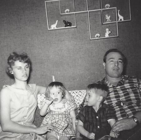 A man and woman sitting on a couch with children