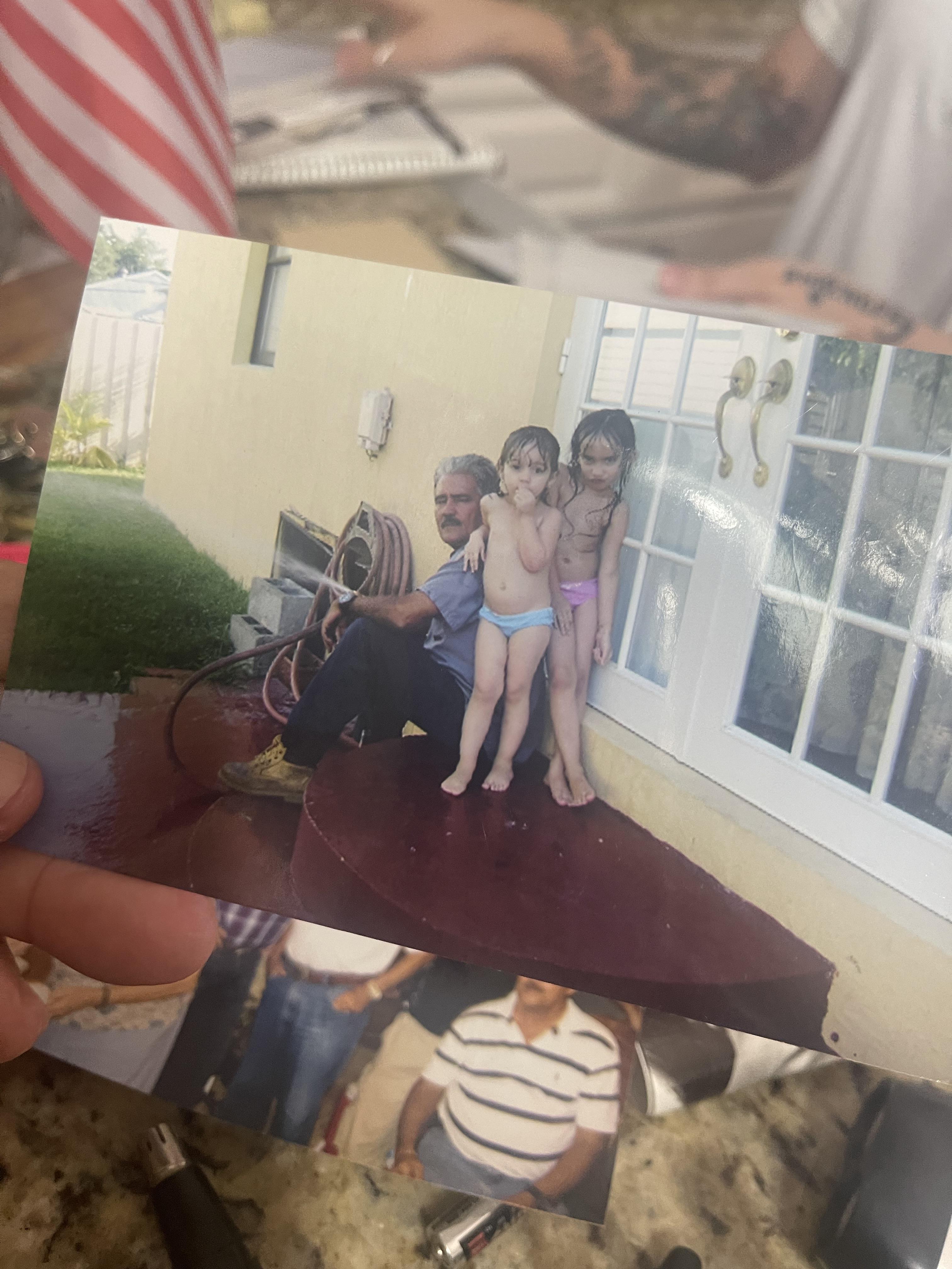 Adults and children share a joyful summer day outside, posing near the house's entrance.