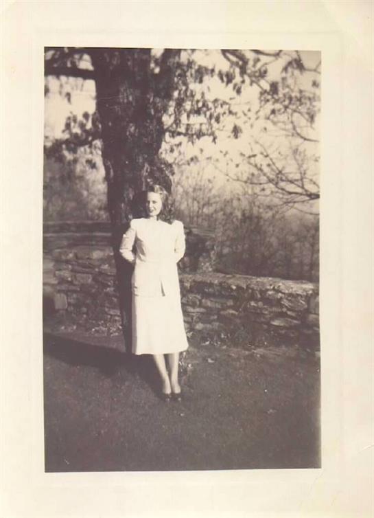 A woman standing next to a tree
