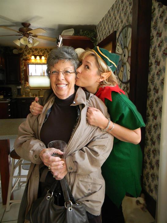 A woman kissing a woman's cheek
