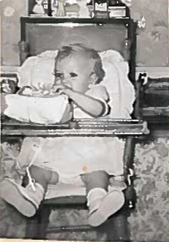 A baby sitting in a high chair