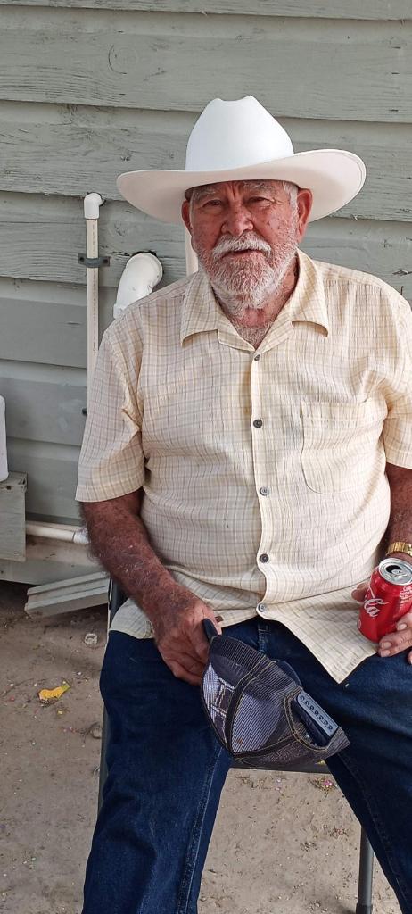 A man sitting in a chair holding a can
