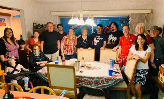 Friends and family come together for a joyful dinner celebration in a cozy home setting.