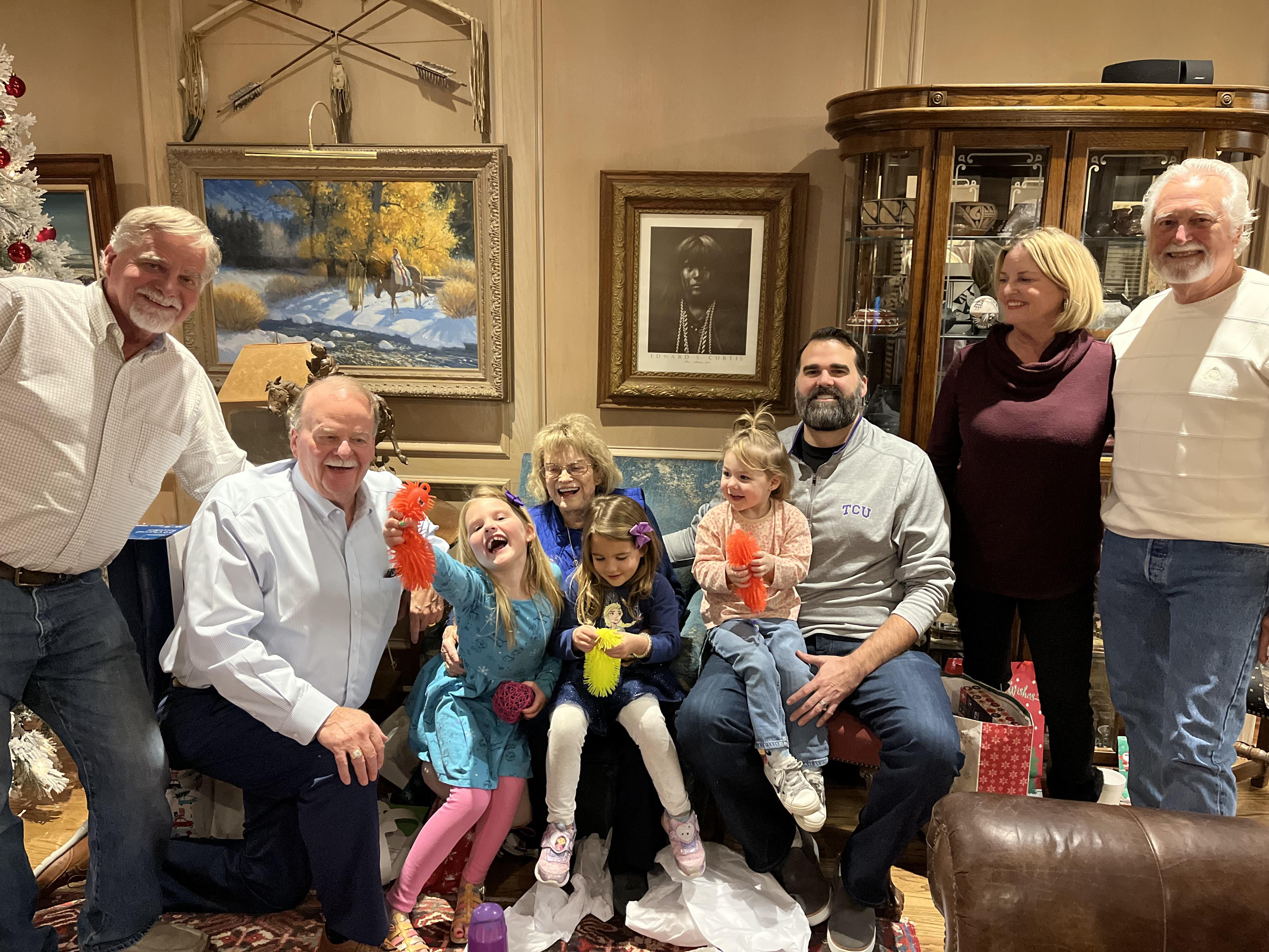 Family gathers for a festive event with children playing and having fun.