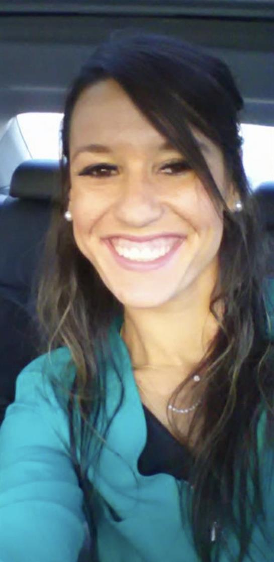 Young woman smiles brightly, enjoying a memorable moment during a car ride at sunset.