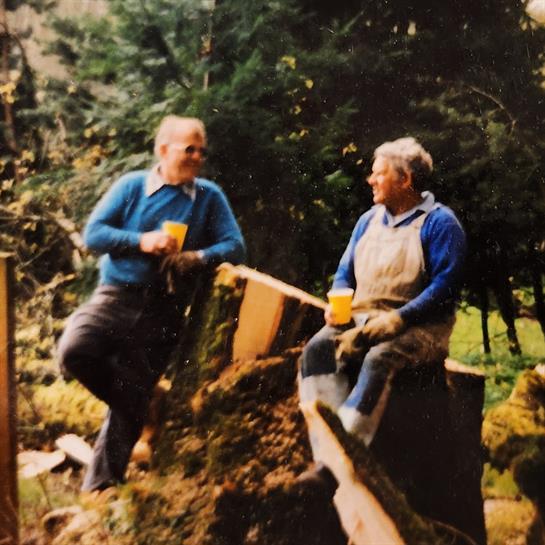 Two men sitting on a stump